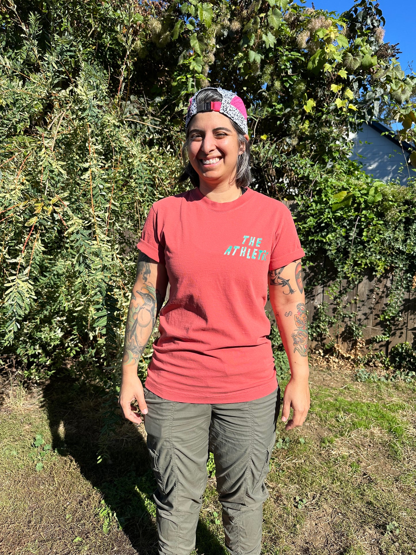 Smizing is hard while the sun is in your eyes! We are obsessed with this shirt. The mineral red is the perfect background for the I LIKE BIKE graphic.