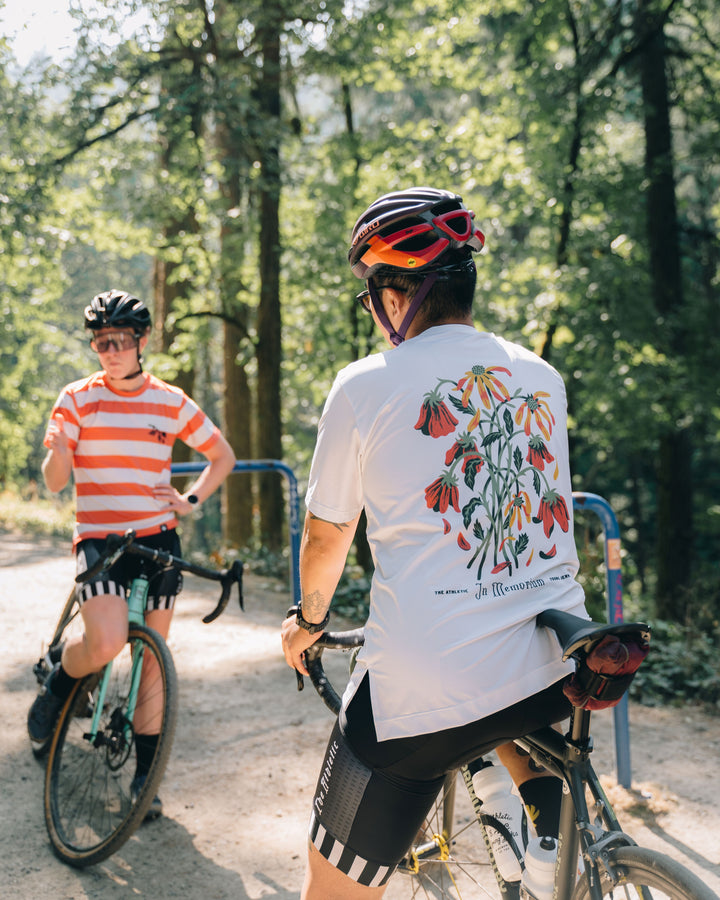 Performance Tech Tee for Running, MTB, Gravel, or Road cycling. Made in the USA by Endo Customs. This lightweight breathable shirt is perfect for when the temperature rises. This is a short sleeve tech tee with flowers on the back. This all white tech tee looks clean and sharp.