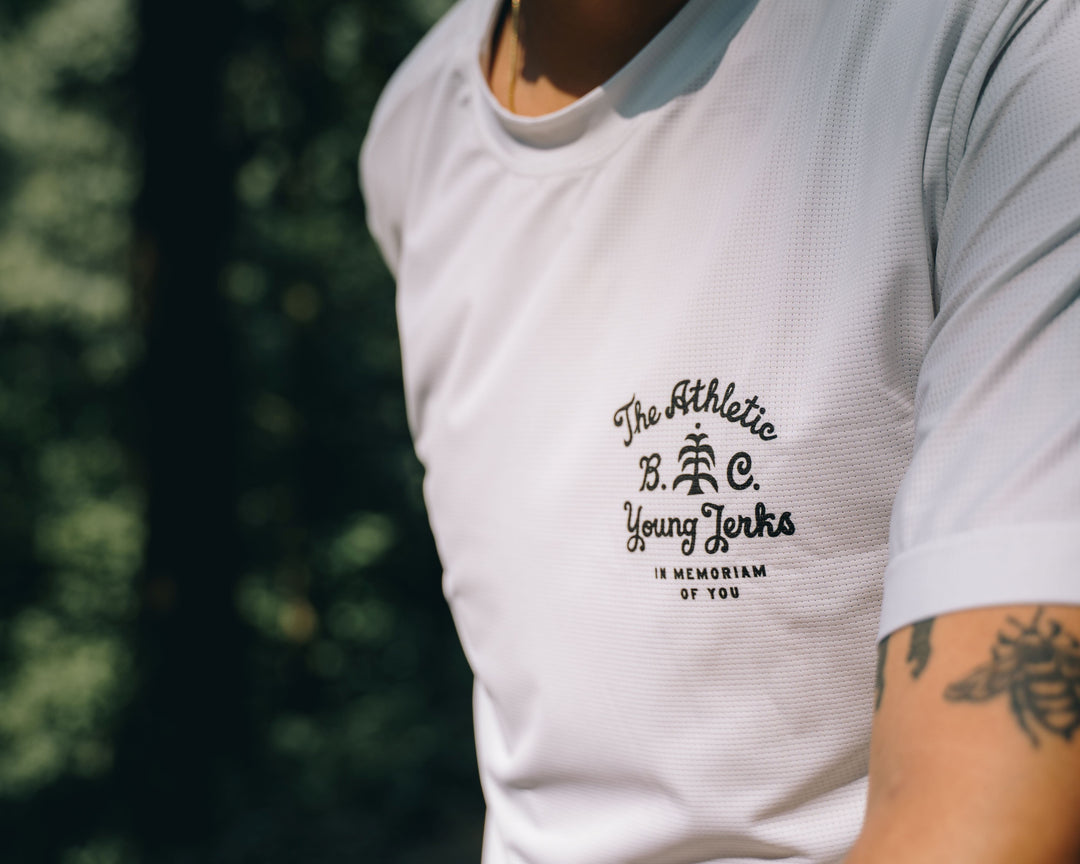 Performance Tech Tee for Running, MTB, Gravel, or Road cycling. Made in the USA by Endo Customs. This lightweight breathable shirt is perfect for when the temperature rises. This is a short sleeve tech tee with flowers on the back. This all white tech tee looks clean and sharp.