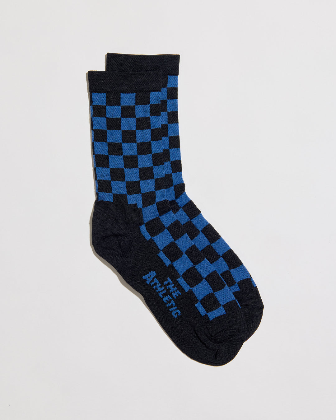 The SUPER TUFF Check Yourself Socks feature a bold checkerboard pattern, adding a rebellious flair to your athletic wear. Crafted for durability and comfort, these socks are perfect for activities like running, cycling, or hitting the gym. Made in the USA with recycled fibers, they combine style, performance, and sustainability