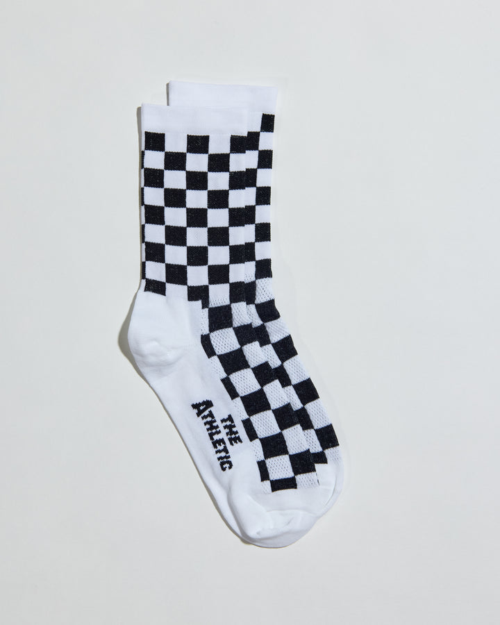 The SUPER TUFF Check Yourself Socks feature a bold checkerboard pattern, adding a rebellious flair to your athletic wear. Crafted for durability and comfort, these socks are perfect for activities like running, cycling, or hitting the gym. Made in the USA with recycled fibers, they combine style, performance, and sustainability