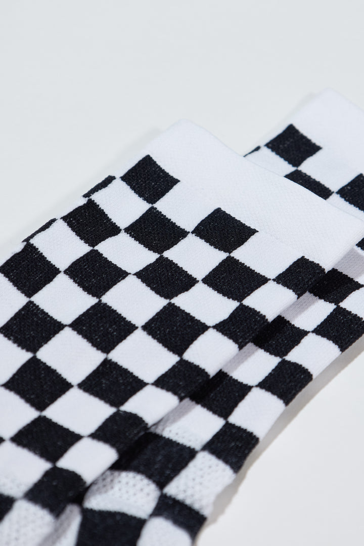 The SUPER TUFF Check Yourself Socks feature a bold checkerboard pattern, adding a rebellious flair to your athletic wear. Crafted for durability and comfort, these socks are perfect for activities like running, cycling, or hitting the gym. Made in the USA with recycled fibers, they combine style, performance, and sustainability