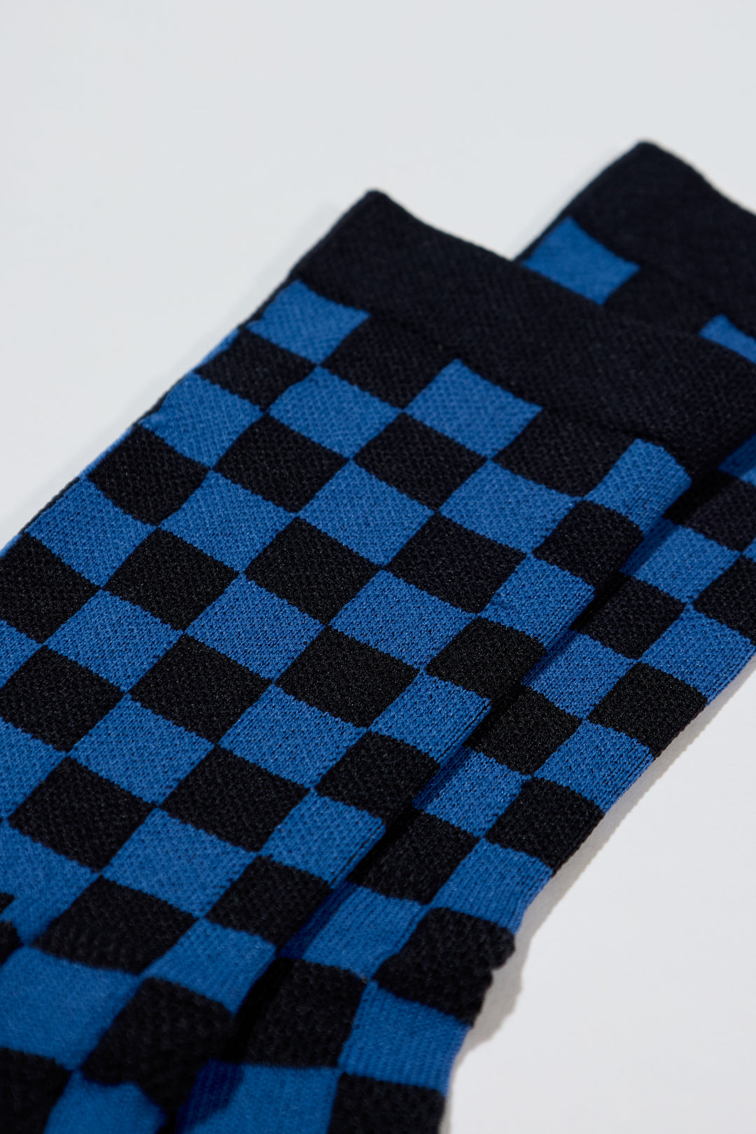 The SUPER TUFF Check Yourself Socks feature a bold checkerboard pattern, adding a rebellious flair to your athletic wear. Crafted for durability and comfort, these socks are perfect for activities like running, cycling, or hitting the gym. Made in the USA with recycled fibers, they combine style, performance, and sustainability