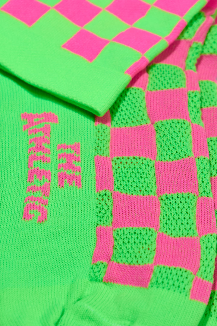 The SUPER TUFF Check Yourself Socks feature a bold checkerboard pattern, adding a rebellious flair to your athletic wear. Crafted for durability and comfort, these socks are perfect for activities like running, cycling, or hitting the gym. Made in the USA with recycled fibers, they combine style, performance, and sustainability