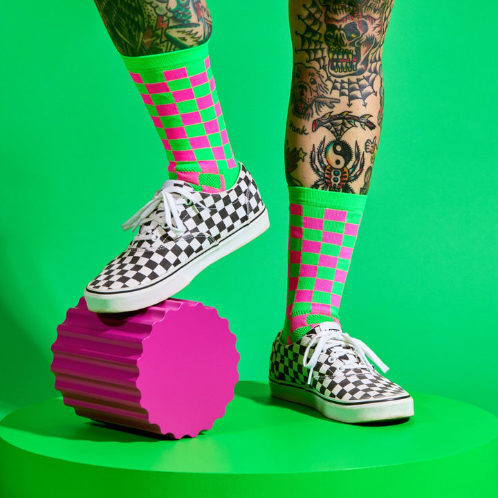 The SUPER TUFF Check Yourself Socks feature a bold checkerboard pattern, adding a rebellious flair to your athletic wear. Crafted for durability and comfort, these socks are perfect for activities like running, cycling, or hitting the gym. Made in the USA with recycled fibers, they combine style, performance, and sustainability