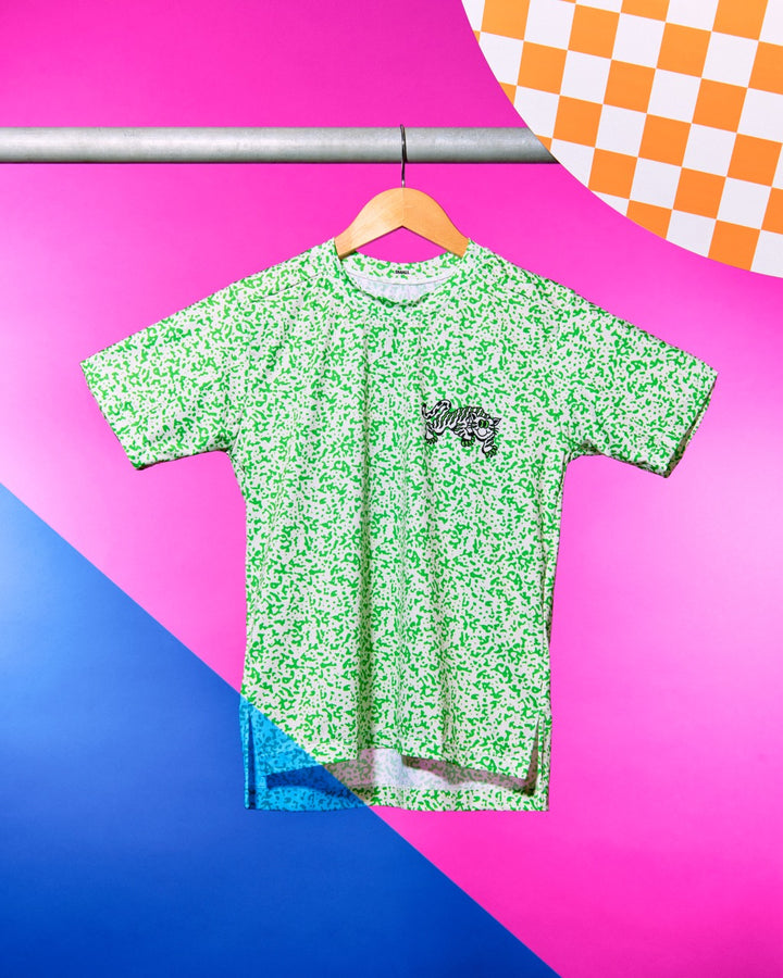 Performance Tech Tee for Running, MTB, Gravel, or Road cycling. Made in the USA by Endo Customs. This lightweight breathable shirt is perfect for when the temperature rises. This is a short sleeve tech tee with a tiger image on the back. Green speckles over a off white color give it a 90's retro look.