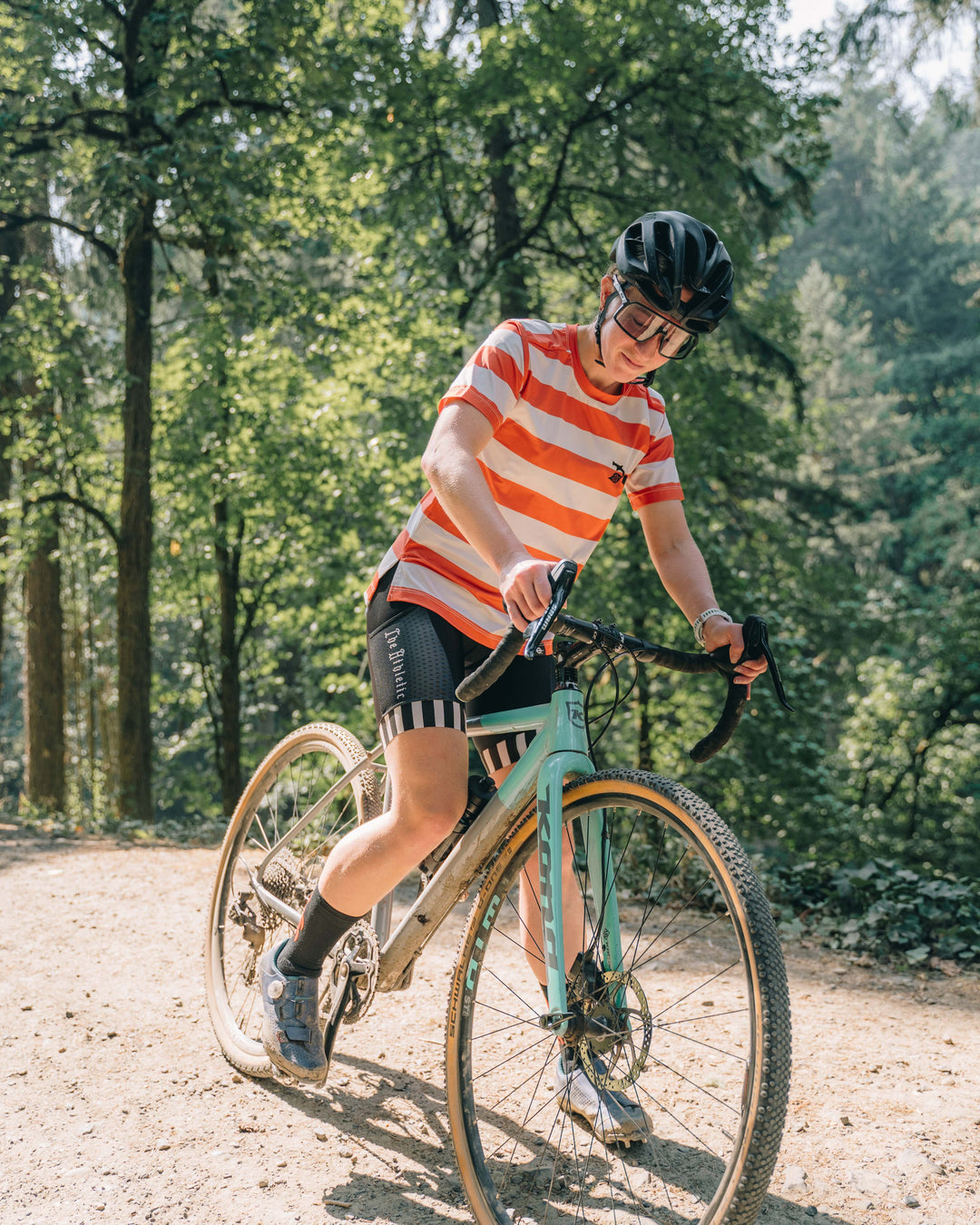 The Women's Waldo Short Sleeve Tech Tee is a versatile performance shirt designed for activities like running, cycling, and cross-training. Crafted in California from Italian-engineered fabrics, it features a lightweight, breathable design with a split side seam at the hem to accommodate lower body movement. This timeless striped tee, adorned with a black rose on the upper left chest, offers both style and functionality for active individuals