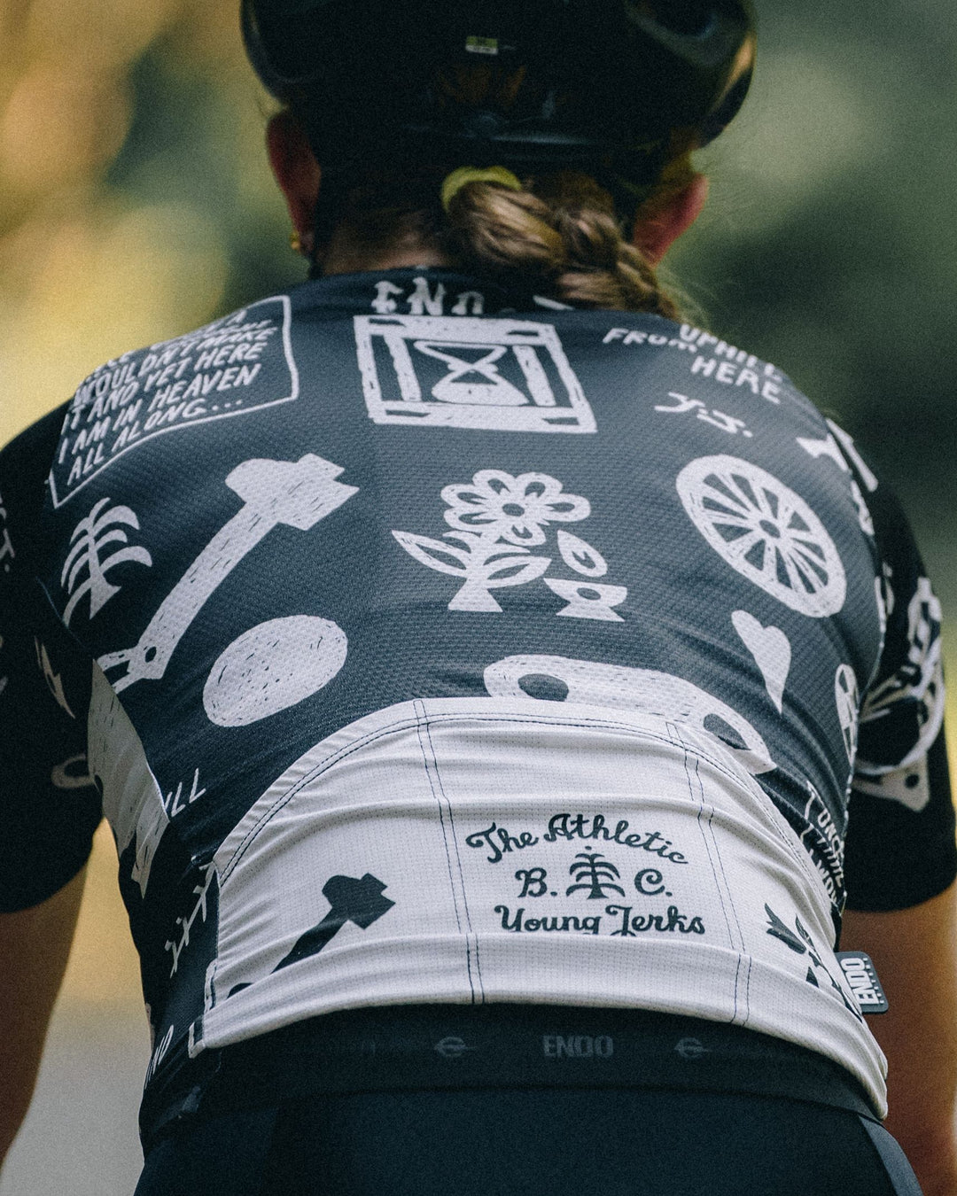 The Women's All Uphill From Here Jersey is a high-performance cycling jersey designed for both gravel and road cycling. Crafted in California from Italian fabrics by Endo Customs, it features a lightweight construction with an embossed rear elastic for added comfort. The jersey showcases a bold black and white design by Young Jerks, emphasizing the "All Uphill From Here" theme