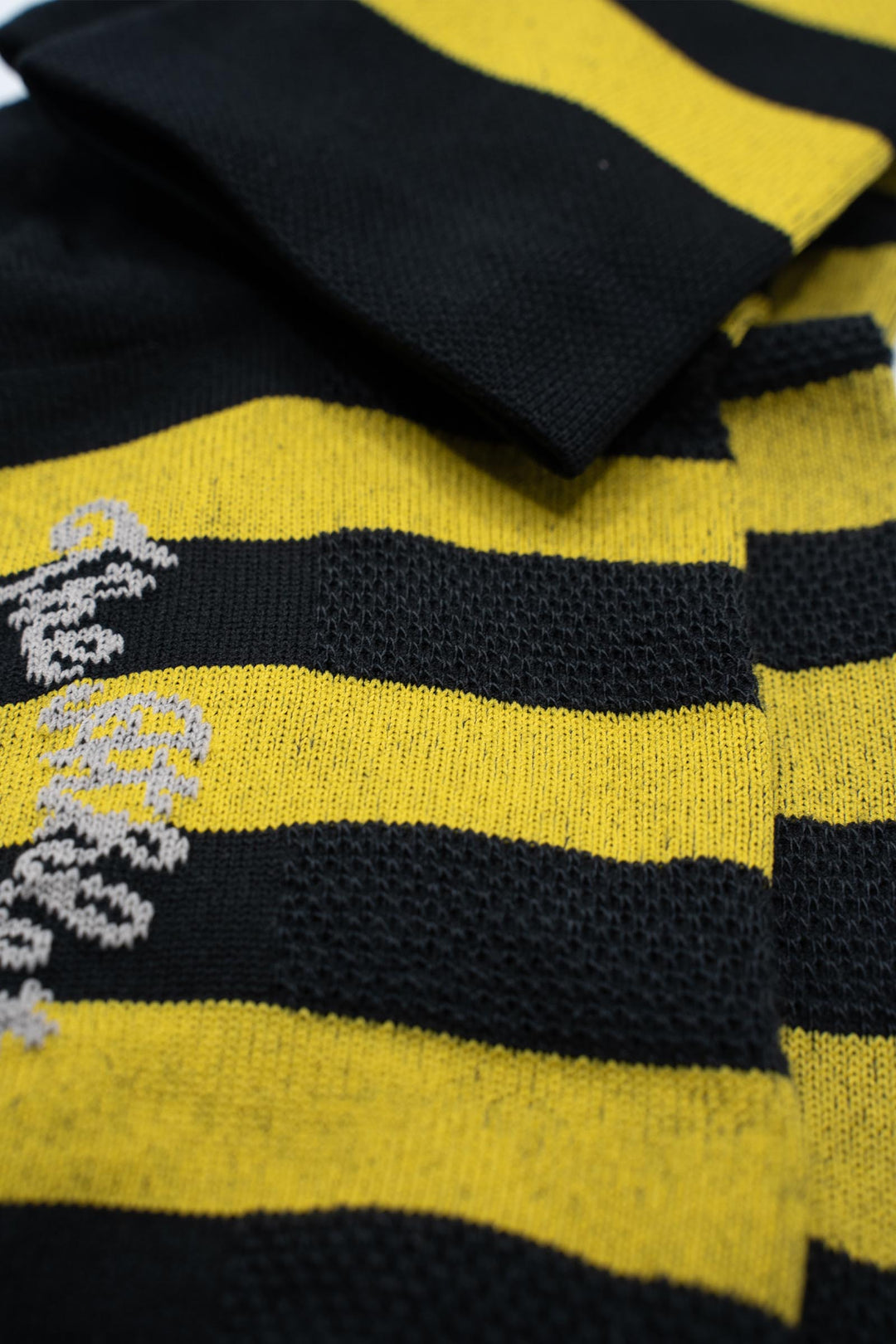 black and yellow striped socks with a skull on either side of the sock