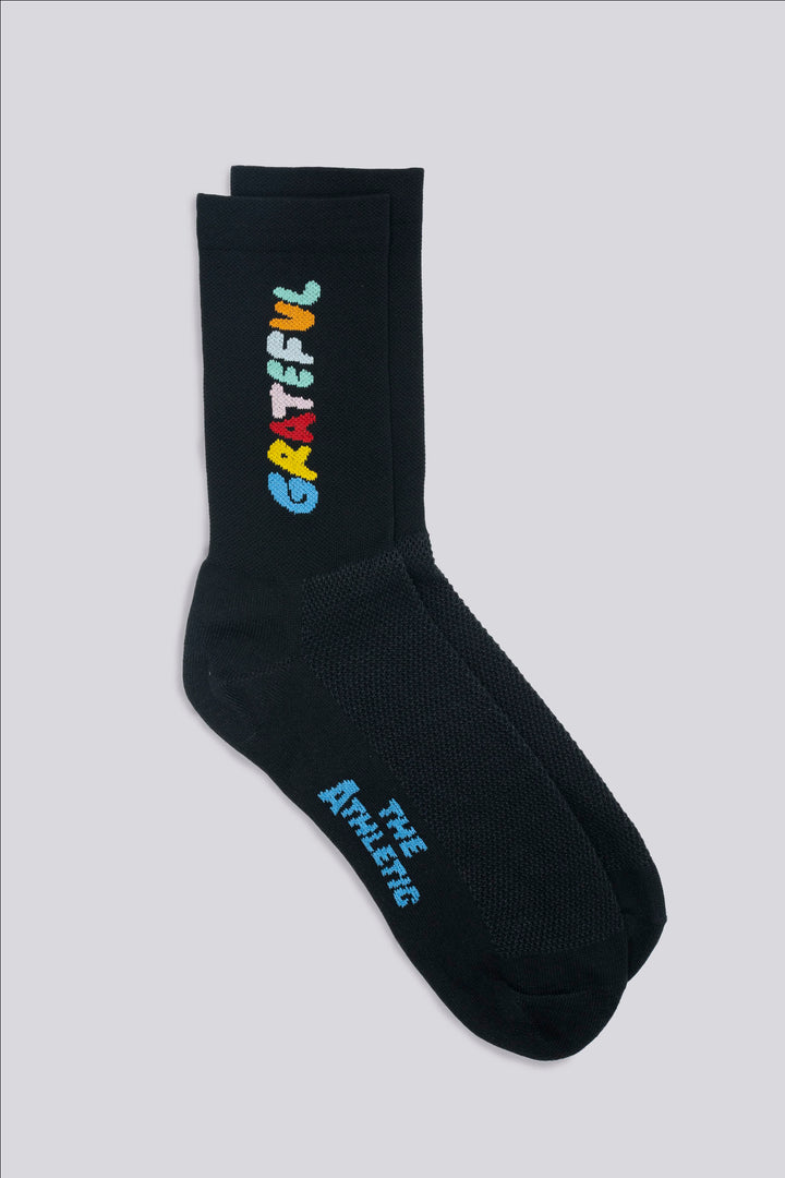 The Grateful Socks are designed to inspire positivity and gratitude, featuring the word "Grateful" prominently displayed. Ideal for cycling, running, and cross-training, these socks combine style and performance. Available in oatmeal with blue text and blue with white text. Made in the USA with recycled fibers, they offer both durability and sustainability