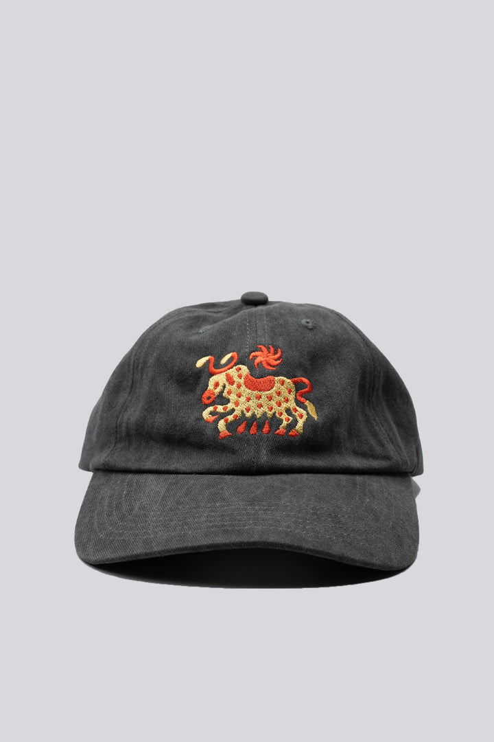 Gray dad hat with a horned cow and a sun embroidered in gold and red and "The Athletic" embroidered in the back