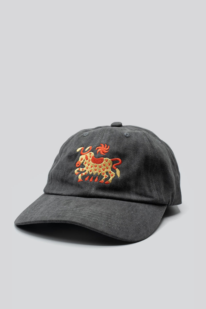 Gray dad hat with a horned cow and a sun embroidered in gold and red and "The Athletic" embroidered in the back