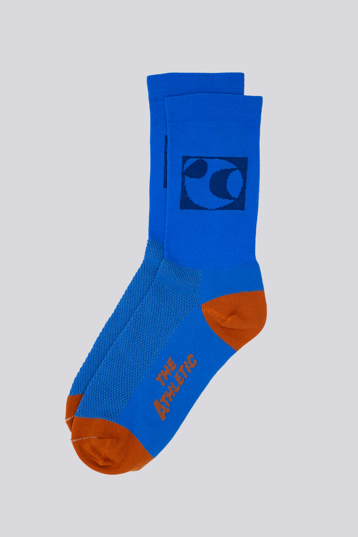 The Moonspin x The Athletic Socks are a collaboration between Moonspin, a women-led mountain biking apparel brand, and The Athletic Community. These socks are available in two colorways: Navy and Blue. Designed to inspire and style your biking adventures, they combine performance with style. Made in the USA with synthetic fibers from post-consumer recycled water bottles, these lightweight socks are breathable, moisture-wicking, and durable—ideal for warm weather cycling and everyday adventures