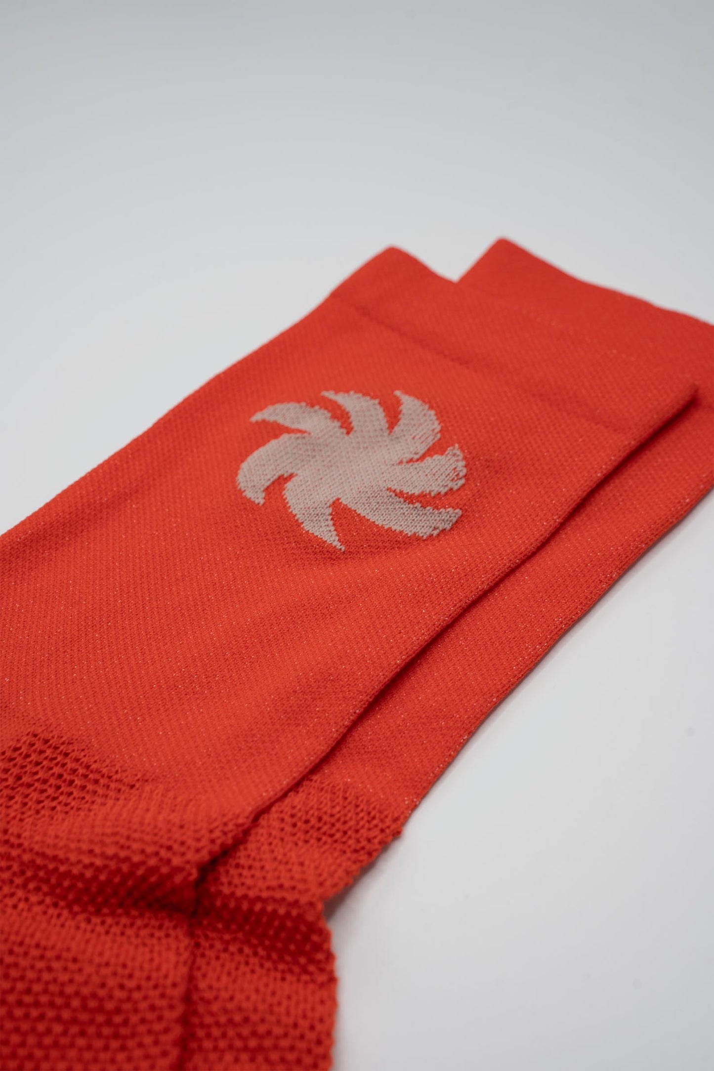 Orange socks with a khaki sun on either side for running or cycling