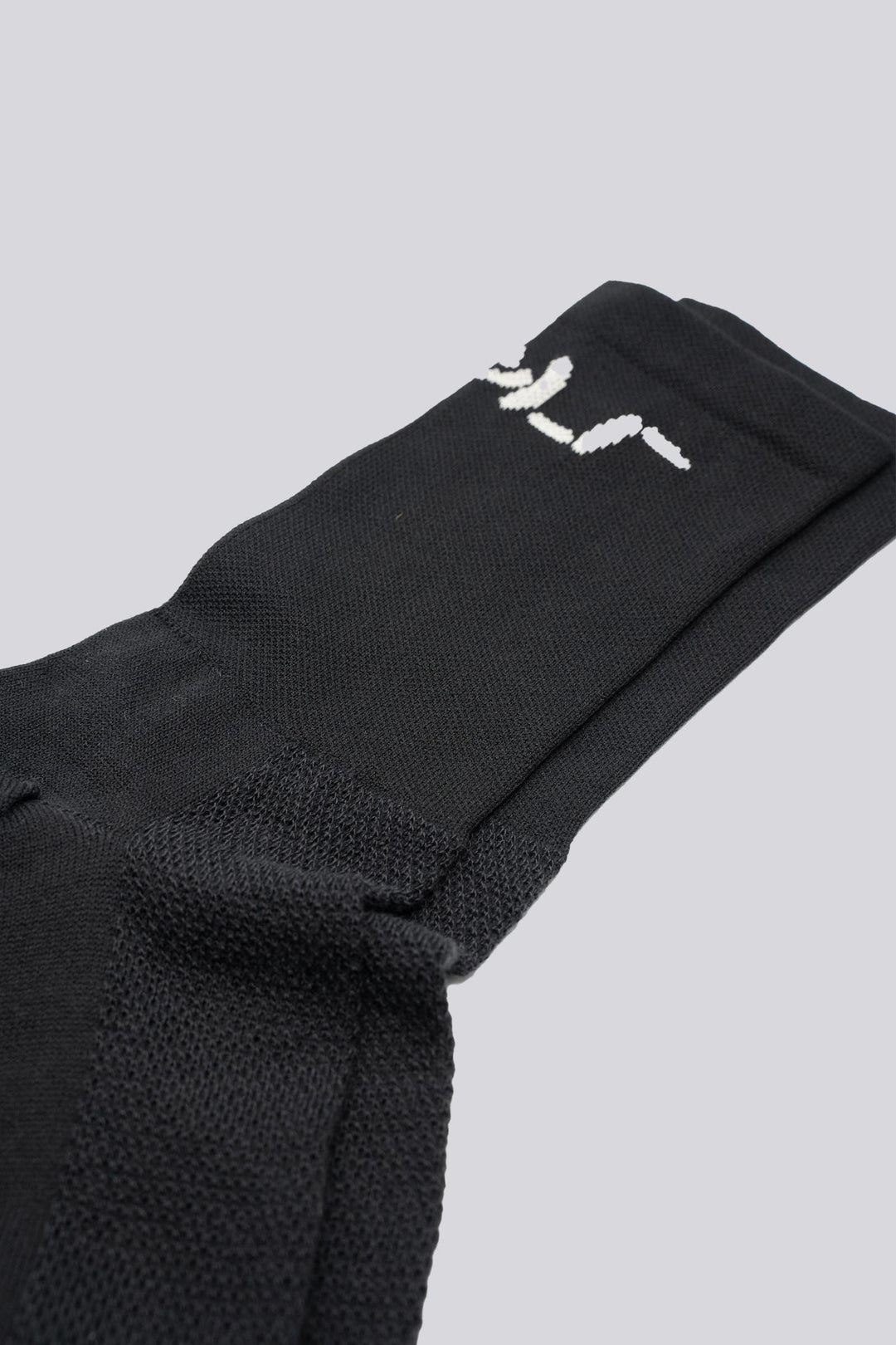 black cycling running sock with shrug emoticon