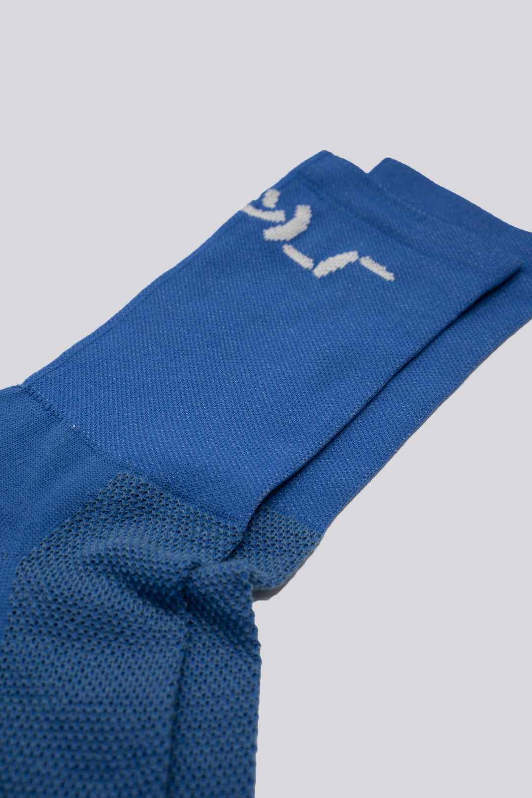 The Shruggie Socks are designed to add a touch of humor to your athletic wear. Crafted from a recycled synthetic fabric blend, these socks offer maximum performance for cycling, running, and cross-training. They feature a medium compression cuff and are suitable for all seasons