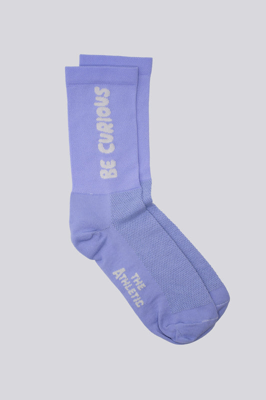 Lavender socks with "Be Curious" on either side of the sock for running and cycling