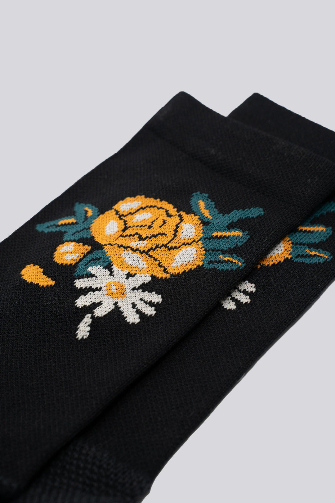 Black sock with a rose design on either side for running and cycling