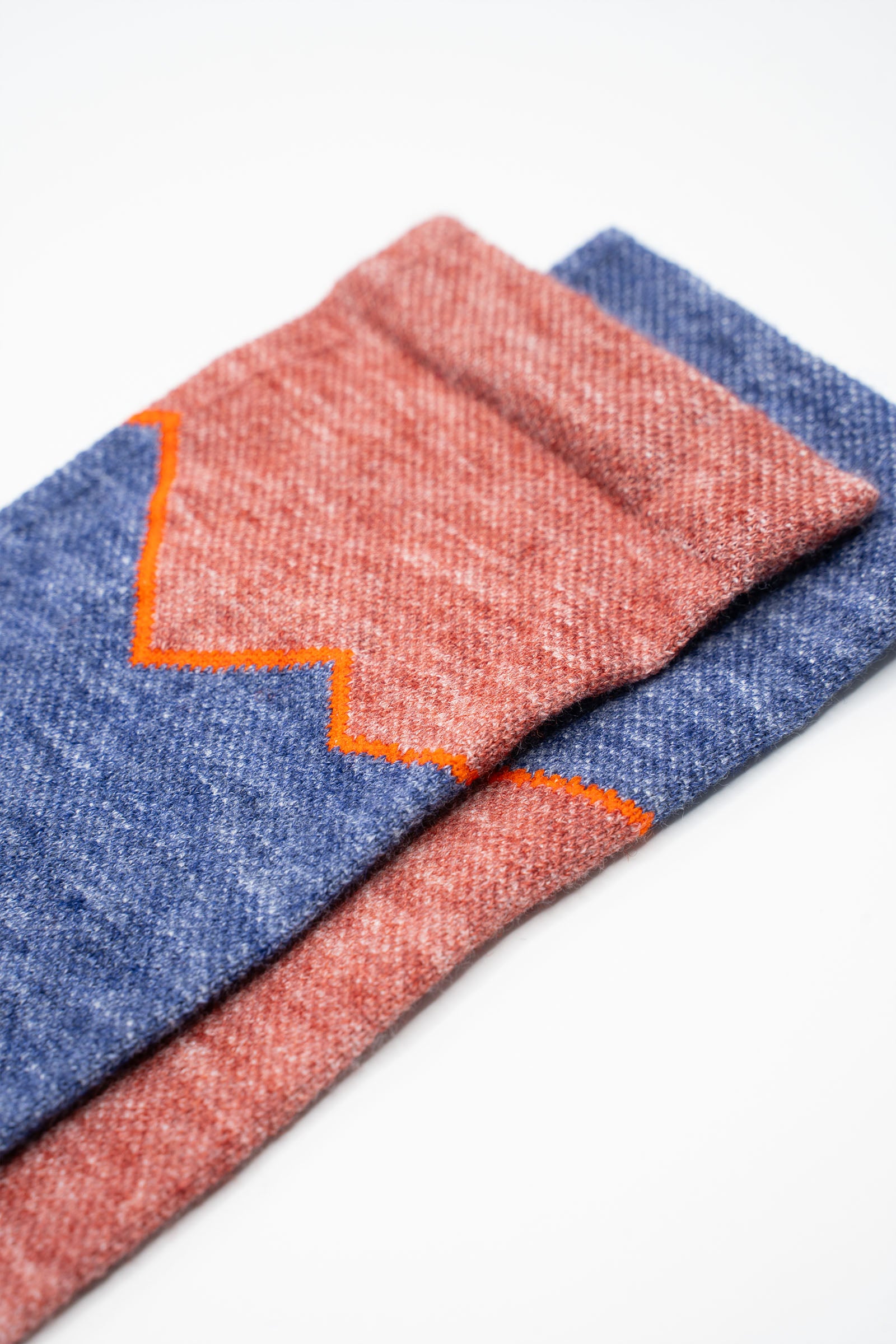 Mismatched red and blue wool socks for running and cycling, a Golden Saddle Cyclery x The Athletic Collab