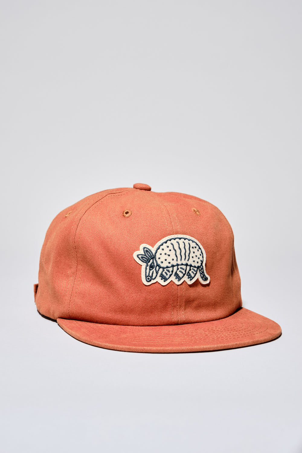 Rust colored embroidered Armadillo hat. The Athletic embroidered in the back