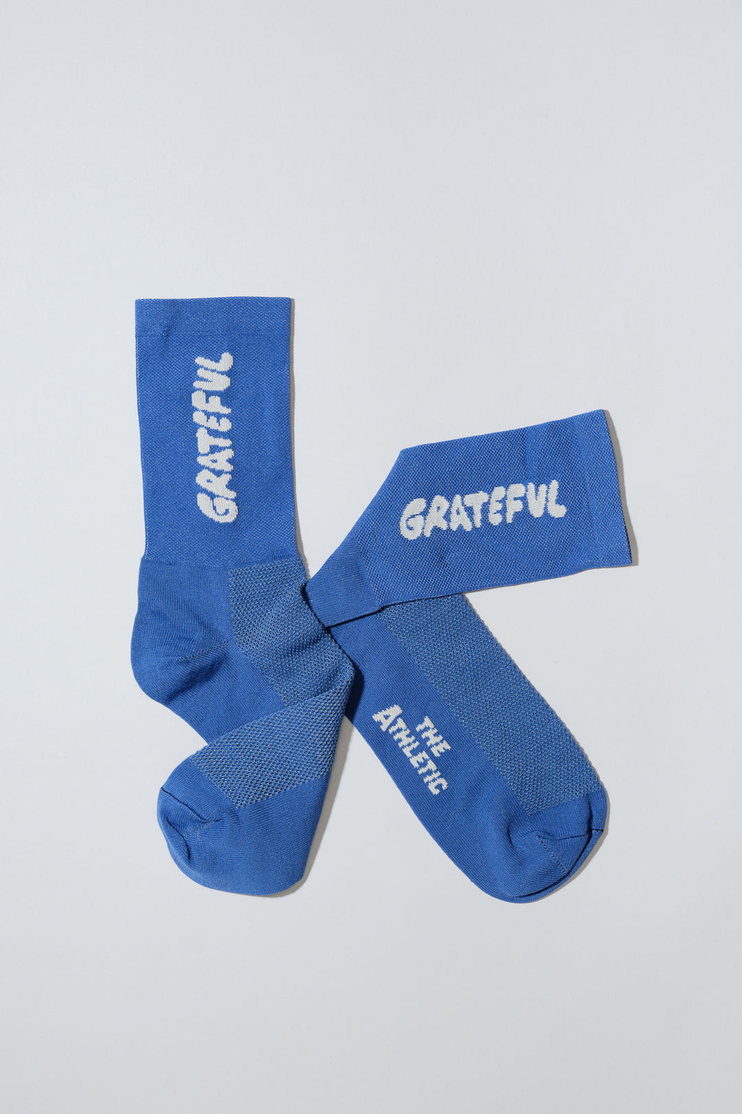 Blue socks with "Grateful" text.