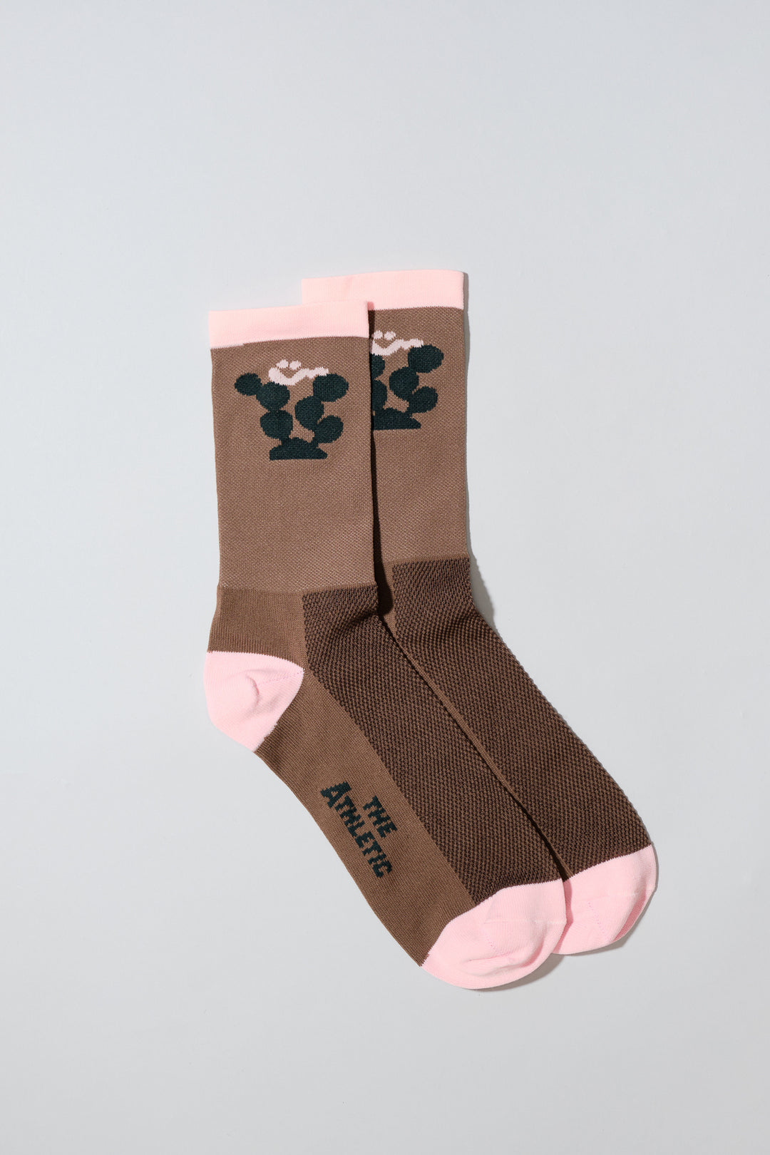 The Happy Cactus Socks, designed by artist Will Bryant, feature a playful cactus and smiley face design. Made in the USA with love, these socks are perfect for adding a touch of fun to your athletic wear. Ideal for cycling, running, and casual wear, they combine style and performance