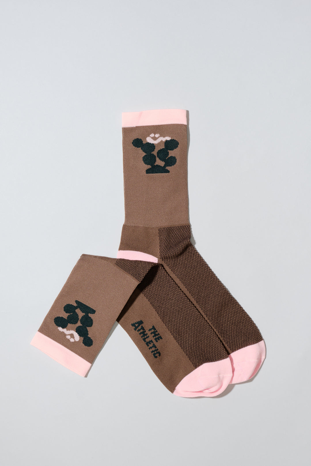 The Happy Cactus Socks, designed by artist Will Bryant, feature a playful cactus and smiley face design. Made in the USA with love, these socks are perfect for adding a touch of fun to your athletic wear. Ideal for cycling, running, and casual wear, they combine style and performance