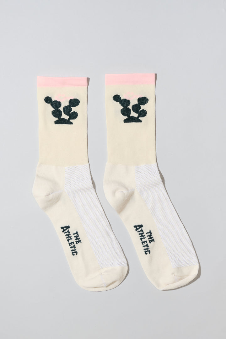 The Happy Cactus Socks, designed by artist Will Bryant, feature a playful cactus and smiley face design. Made in the USA with love, these socks are perfect for adding a touch of fun to your athletic wear. Ideal for cycling, running, and casual wear, they combine style and performance