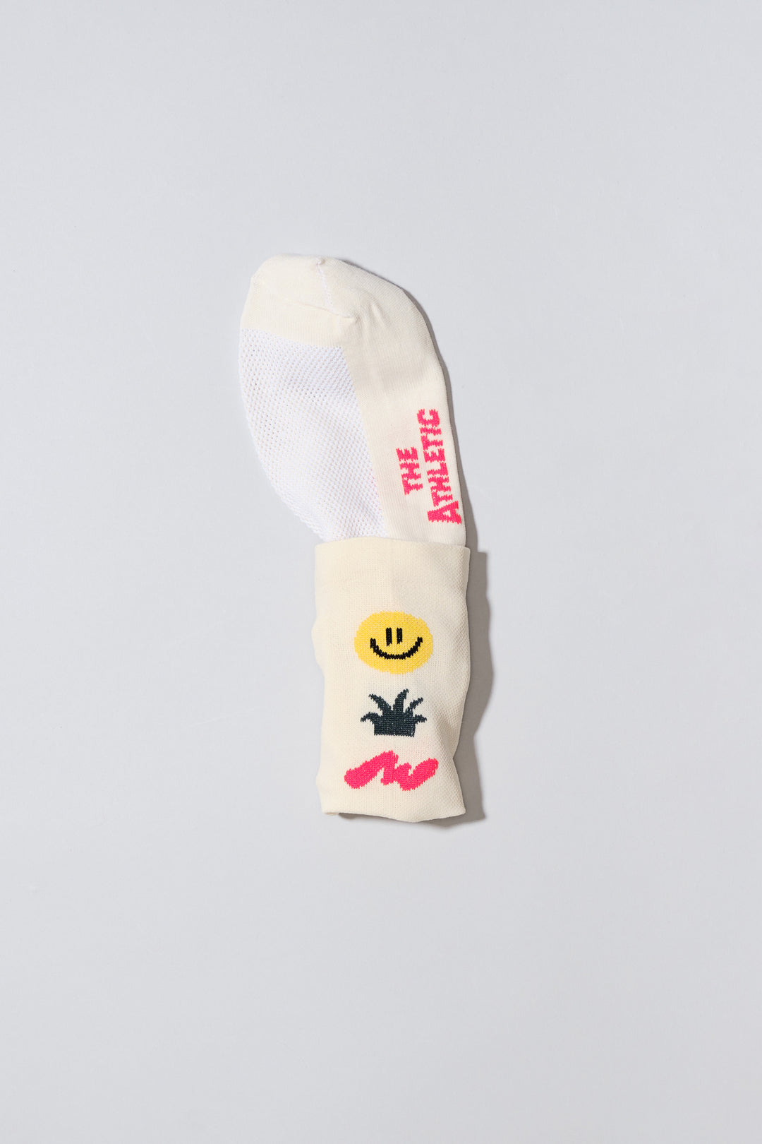 The Happy Trio Socks feature a playful design with a smiley face, cactus, and squiggle, available in off-white and black color options. Ideal for cycling, running, and cross-training, these socks combine style and performance. Made in the USA with love, they offer both durability and comfort