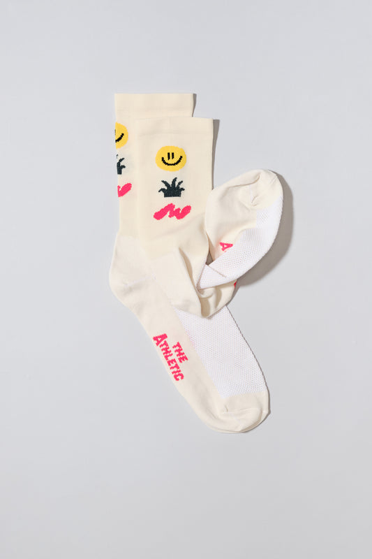 off white socks with a smiley face, cactus and squiggle