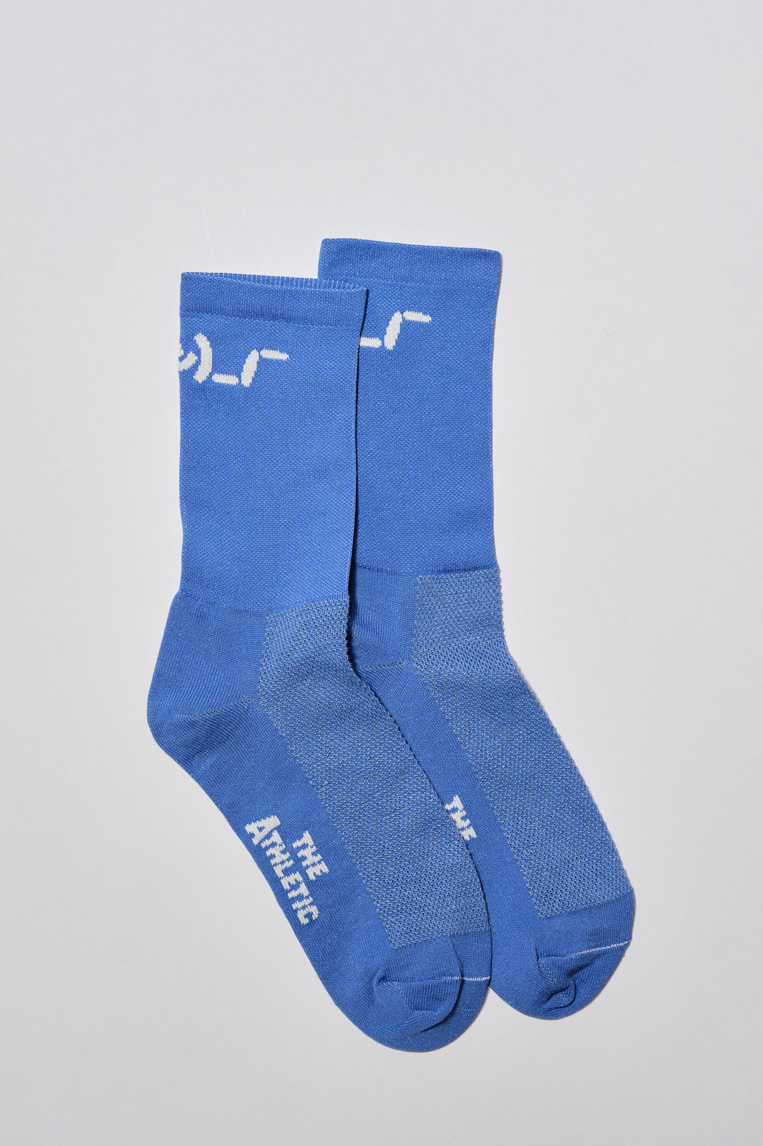 The Shruggie Socks are designed to add a touch of humor to your athletic wear. Crafted from a recycled synthetic fabric blend, these socks offer maximum performance for cycling, running, and cross-training. They feature a medium compression cuff and are suitable for all seasons