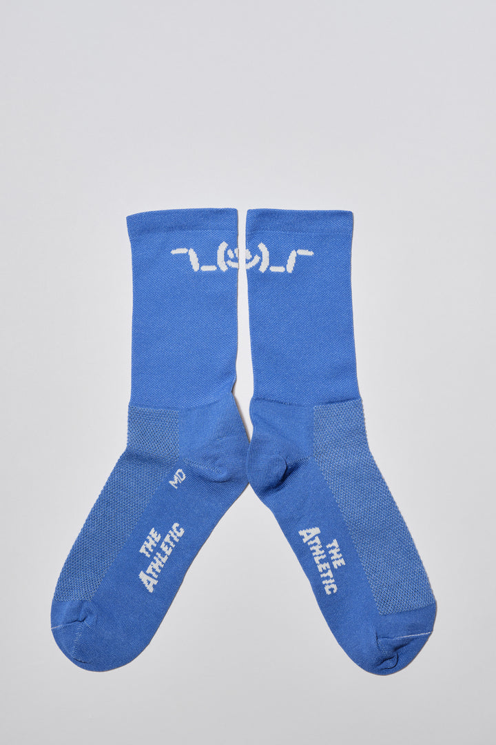 The Shruggie Socks are designed to add a touch of humor to your athletic wear. Crafted from a recycled synthetic fabric blend, these socks offer maximum performance for cycling, running, and cross-training. They feature a medium compression cuff and are suitable for all seasons