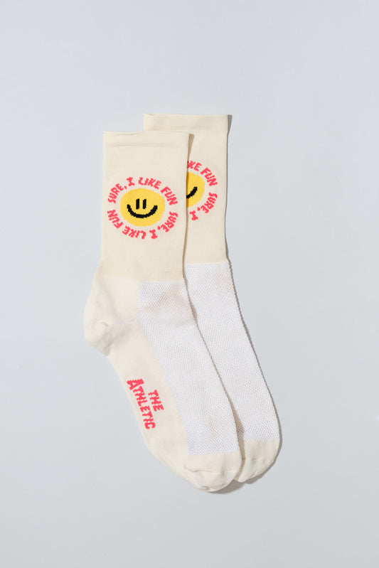 Smiley face socks with "Sure, I like fun" caption. Socks are oatmeal colored.